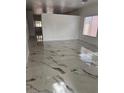 Bright, open living room with glossy marble floors and plenty of natural light at 6022 Highland Gardens Dr, North Las Vegas, NV 89031