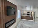 Open-concept living room, highlighting the modern electric fireplace and stunning marble floors at 6022 Highland Gardens Dr, North Las Vegas, NV 89031
