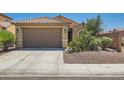 Charming single-story home with a two-car garage, desert landscaping, and a well-maintained front yard at 6446 Button Quail St, North Las Vegas, NV 89084