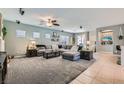 Spacious living room featuring carpeted floors, a ceiling fan, recessed lighting, and stylish decor at 6446 Button Quail St, North Las Vegas, NV 89084