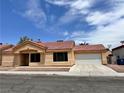 Inviting single-story home with a well-manicured front yard and attached two-car garage at 6600 Silver Penny Ave, Las Vegas, NV 89108