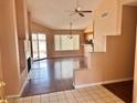 Spacious living room featuring a fireplace, hardwood floors, and natural light from sliding glass doors at 6600 Silver Penny Ave, Las Vegas, NV 89108