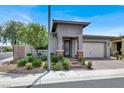 Inviting single-story home featuring a cozy front porch and a well-kept yard at 676 Otter Brook St, Henderson, NV 89011