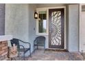 Charming front porch with decorative door and cozy seating area at 676 Otter Brook St, Henderson, NV 89011