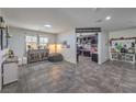 Spacious living area showcasing tile floors and a view into an adjacent room, blending comfort and functionality at 689 Sea Star St, Henderson, NV 89002