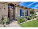 Close up of front entrance featuring a decorative wrought iron gate and manicured landscape at 724 Smokey Mountain Ave, Henderson, NV 89012