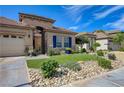 Beautiful house showcasing a well-maintained yard, rock accents, and a desert landscape at 724 Smokey Mountain Ave, Henderson, NV 89012