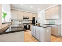 Modern kitchen with stainless steel appliances, granite countertops, and ample cabinet space at 7316 Childers Ave, Las Vegas, NV 89178