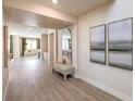 Modern entryway with a bench, mirror, and artwork, leading to the living and dining areas at 7665 Serenity Bay Ln # Lot 58, North Las Vegas, NV 89084