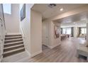 Bright hallway leading to the kitchen and dining area, with a staircase on the left at 7665 Serenity Bay Ln # Lot 58, North Las Vegas, NV 89084