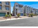 View of a modern three-story townhome with unique round window and blue skies at 8060 Haywood Estate Ave, Las Vegas, NV 89113