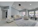 Spacious living room with plush seating, modern lighting, and views of the outdoors at 8150 Beaverbrook Way, Las Vegas, NV 89123