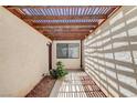 Enclosed patio featuring a wood pergola, desert landscaping and lots of natural light at 8233 Willeta Ave, Las Vegas, NV 89145