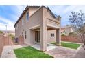 The backyard has a covered patio with access to a small balcony on the second floor at 8745 Dodds Canyon St, Las Vegas, NV 89131