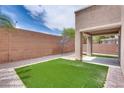 The backyard features a small grassy area, low-maintenance gravel, and a covered patio at 8745 Dodds Canyon St, Las Vegas, NV 89131