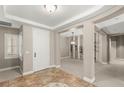 Inviting foyer with tiled floor, neutral walls, white door, and views into a dining room at 900 Cantura Mills Rd, Henderson, NV 89052