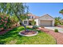 Beautiful two-story home boasts mature trees, landscaping, and an attached garage at 9817 Dardanelle Ct, Las Vegas, NV 89117