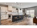 Modern kitchen featuring a large center island, stainless steel appliances, and an adjacent dining area at 9870 Fisher Bay Ct, Las Vegas, NV 89178