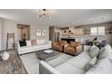 Spacious living room showcasing contemporary decor and an open layout to the kitchen at 9870 Fisher Bay Ct, Las Vegas, NV 89178