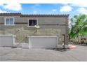 Inviting townhome showcasing a private garage with adjacent window at 10450 Gold Shadow Ave, Las Vegas, NV 89129