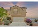 Charming two-story home with a two-car garage, stucco facade and well-manicured landscaping at 10650 Little Horse Creek Ave, Las Vegas, NV 89129
