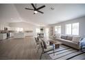 Bright open-concept living room, kitchen, and dining area filled with natural light at 10712 Aire Dr, Las Vegas, NV 89144