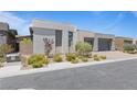 Contemporary home with modern design, minimalist landscaping, neutral color scheme, and paved driveway at 10927 White Clay Dr, Las Vegas, NV 89135