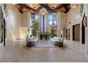 Expansive living room with soaring ceilings, fireplace, grand windows, and stylish decor, ideal for entertaining at 11 Golden Sunray Ln, Las Vegas, NV 89135