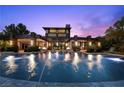 Back of house showing a sparkling swimming pool with underwater lights, complemented by the home's architectural design at 11 Golden Sunray Ln, Las Vegas, NV 89135