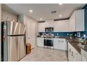 Modern kitchen features stainless steel appliances and white cabinetry at 1130 E Dorrell Ln, North Las Vegas, NV 89086