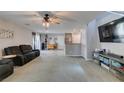 Bright living room featuring plush carpet, ceiling fan, and media center at 1130 E Dorrell Ln, North Las Vegas, NV 89086