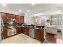Stylish kitchen with dark cabinets, stainless steel appliances, and open layout at 11402 Newton Commons Dr # 102, Las Vegas, NV 89135