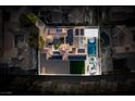 Stunning aerial view of a luxury home with a pool, solar panels, outdoor seating, and lush landscaping at 11830 Kingsbarns Ct, Las Vegas, NV 89141