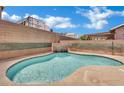 Inviting backyard pool with a waterfall feature and ample space for relaxation at 1335 Passiflora Dr, Henderson, NV 89002