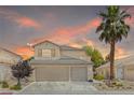 Charming two-story home with a well-maintained lawn, mature palm tree and a three car garage at 1906 Desert Sage Ave, North Las Vegas, NV 89031