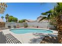 Private backyard featuring a sparkling in-ground pool, mature trees, and an intimate seating area at 1906 Desert Sage Ave, North Las Vegas, NV 89031