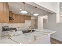 Modern kitchen featuring quartz countertops, stainless steel appliances, and a stylish gold faucet at 2117 Desert Peak Rd, Las Vegas, NV 89134