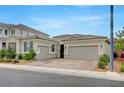 Street view of a charming single-story home with a two-car garage and desert landscaping at 2433 Amatrice St, Henderson, NV 89044
