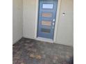 Stylish blue front door with decorative glass panels and modern hardware with a paved entry at 289 Aravalli Crest St, Henderson, NV 89015