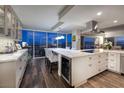 Modern kitchen featuring marble countertops, stainless steel appliances, and a city view through large windows at 3111 Bel Air Dr # 20H, Las Vegas, NV 89109
