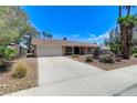 Charming single story home featuring a spacious driveway and xeriscaped front yard at 3360 Paso Andres St, Las Vegas, NV 89146