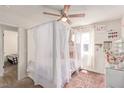 Bedroom featuring a decorative canopy bed frame, soft pink rug, and natural light at 3417 Lillis Cir, North Las Vegas, NV 89030