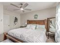 Comfortable main bedroom features a wooden bed frame, a ceiling fan, and natural light at 3417 Lillis Cir, North Las Vegas, NV 89030
