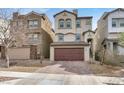Two-story home with a two-car garage and a well-maintained, xeriscaped front yard and tile roof at 382 Gracious Way, Henderson, NV 89011