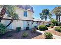 Inviting townhome featuring mature landscaping, a sidewalk and a red tile roof at 3974 Palos Verdes St, Las Vegas, NV 89119