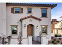 Inviting two-story home with symmetrical windows, desert landscaping, and warm exterior paint tones at 4 Lomita Heights Dr, Las Vegas, NV 89138