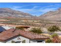 Scenic view overlooking the desert landscape with mountains and neighborhood rooftops at 4 Lomita Heights Dr, Las Vegas, NV 89138
