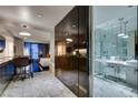A modern interior featuring a marble floor, stainless steel kitchen, and a bathroom with glass shower and double vanity at 4381 Flamingo Rd # 2612, Las Vegas, NV 89103