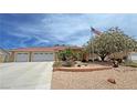 Lovely single-story house features a large driveway and desert landscaping with charming details at 4650 Stoneham St, Pahrump, NV 89061