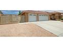 The property has a spacious three-car garage and an iron security gate at 4650 Stoneham St, Pahrump, NV 89061